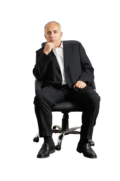 Senior man sitting on office chair — стоковое фото