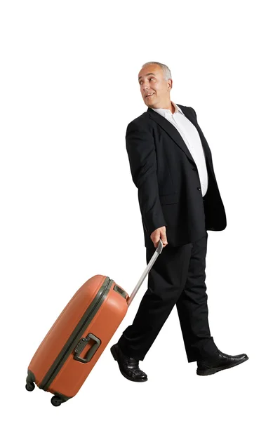 振り返ってみると笑みを浮かべてのスーツケースを持つ男 — ストック写真