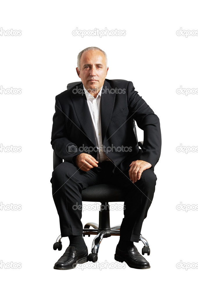 serious businessman sitting on office chair