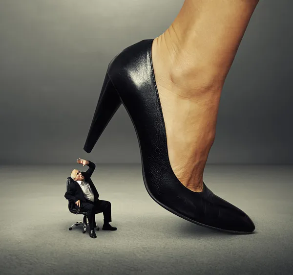 Senior man under big female heel — Stock Photo, Image