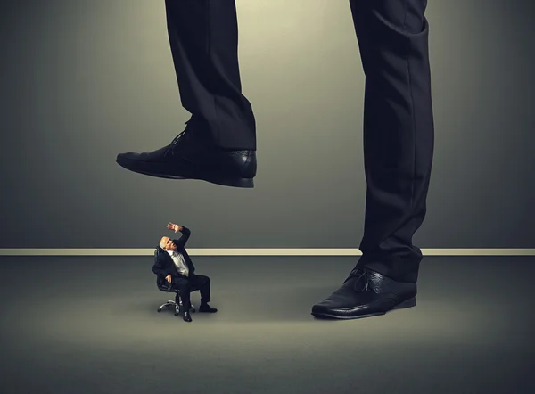 Senior businessman under big leg his boss — Stock Photo, Image