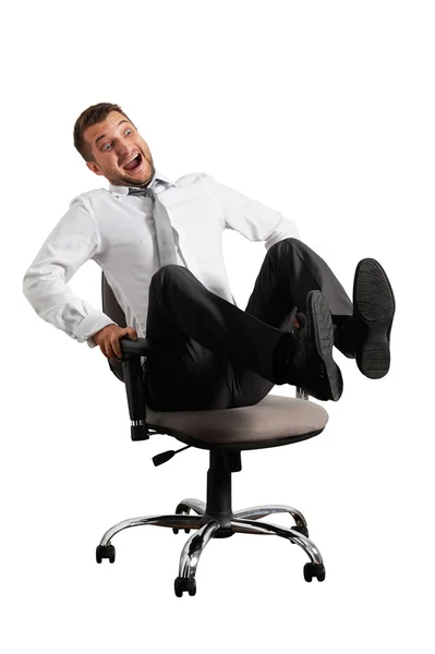 Merry businessman rolling on the office chair — Stock Photo, Image