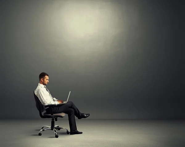 concentrated businessman sitting in dark room