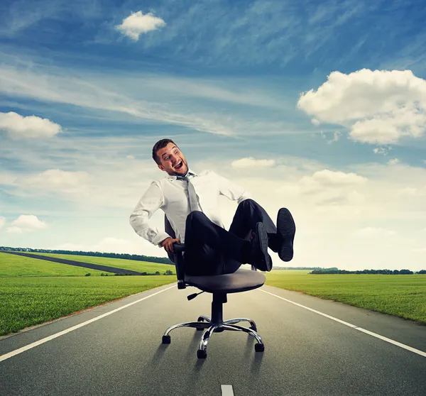 Laughing man sitting on the office chair — Stock Photo, Image