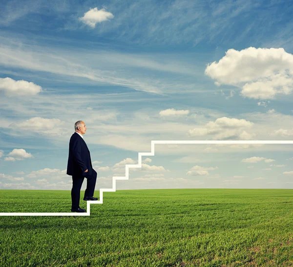 Man in formal wear stepping up the stairs — Stock Photo, Image