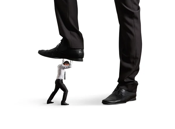 Man under big leg his boss — Stock Photo, Image