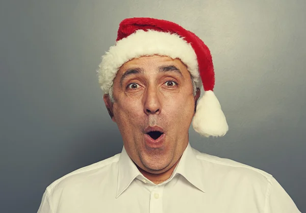 Senior man in red christmas hat — Stock Photo, Image