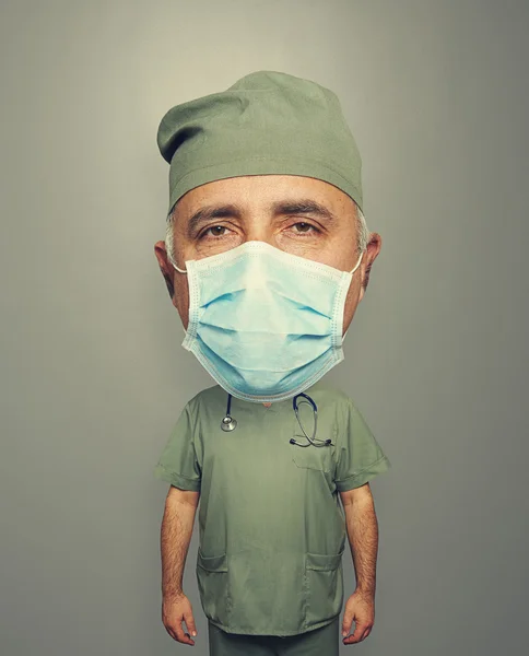 Bighead doctor in mask and uniform — Stock Photo, Image