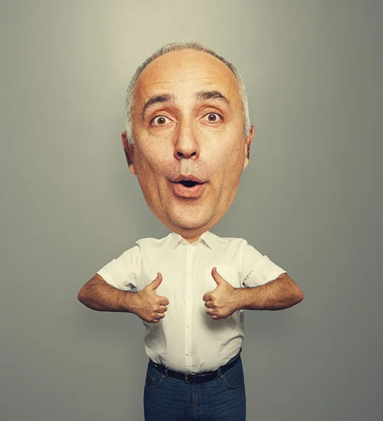 Senior man with big head showing thumbs up — Stock Photo, Image