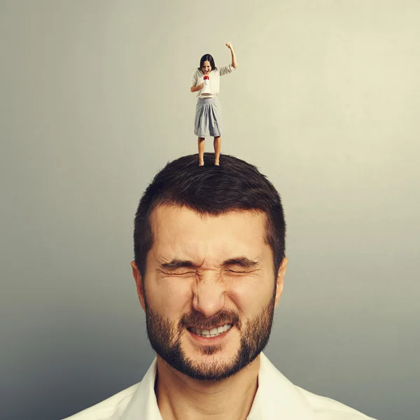 Woman shouting at megaphone at dissatisfied man — Stock Photo, Image