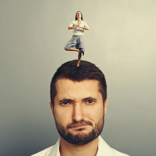 Woman standing on the head of displeased man — Stock Photo, Image