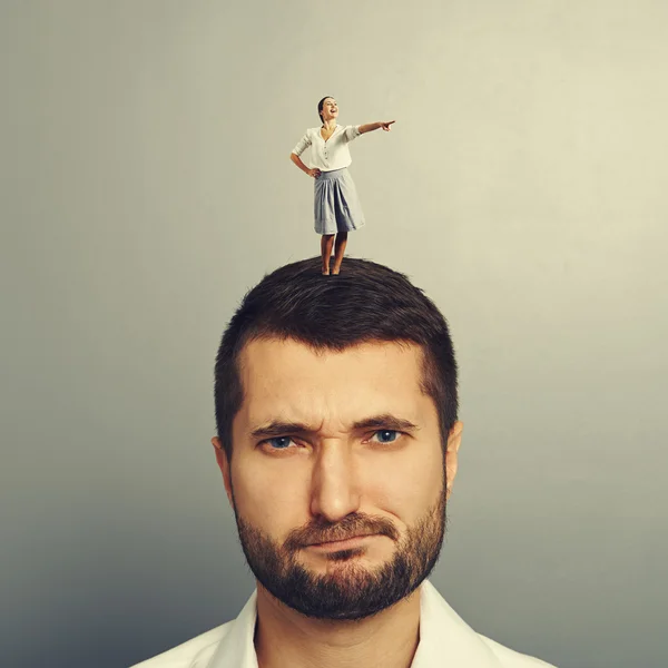 Woman standing on the displeased man — Stock Photo, Image