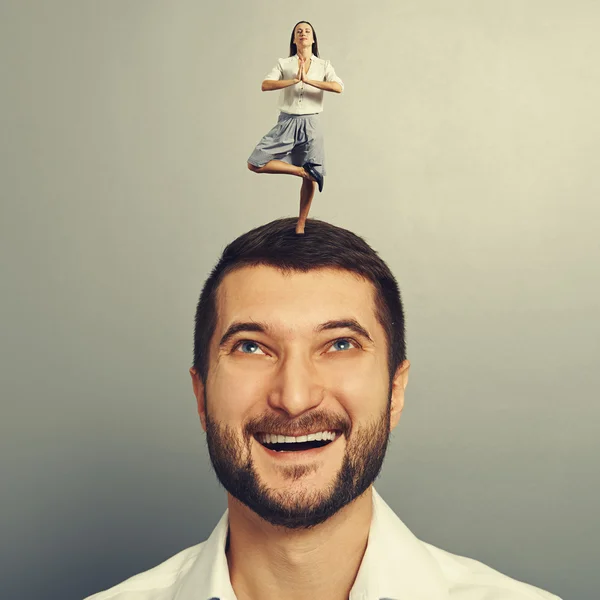 Woman standing on the head of happy man — Stock Photo, Image