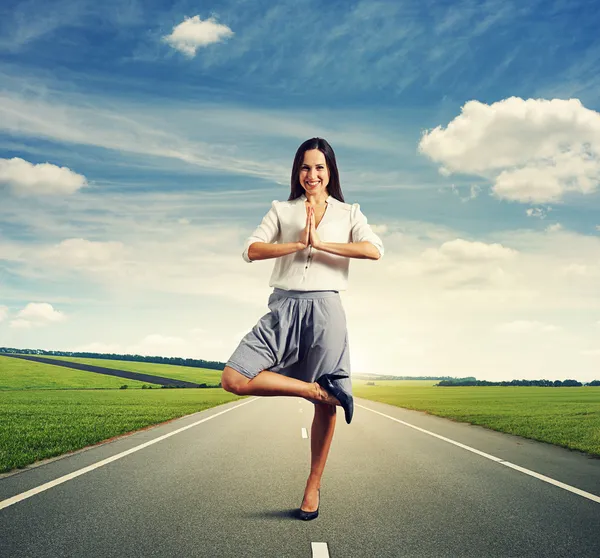 Woman in yoga pose standing on the road — Stock Photo, Image