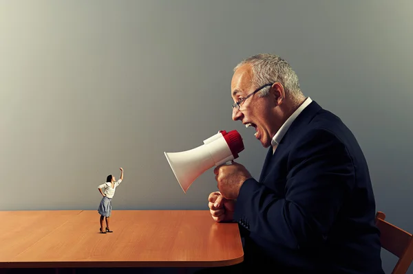 Woman showing fist at big angry boss — Stock Photo, Image