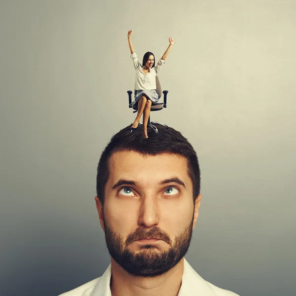 Happy woman sitting on the stressed man — Stock Photo, Image