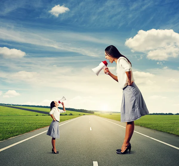 Emotional two women with megaphone — Stock Photo, Image