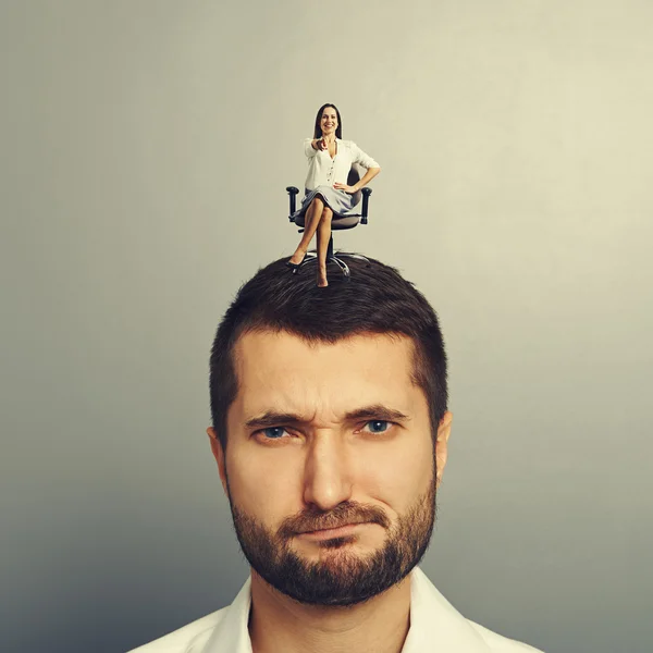 Woman sitting on the displeased man — Stock Photo, Image
