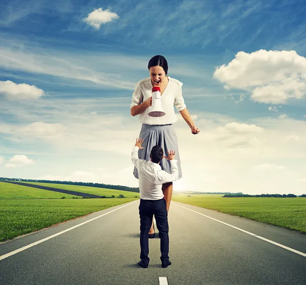 Woman shouting at small scared businessman — Stock Photo, Image