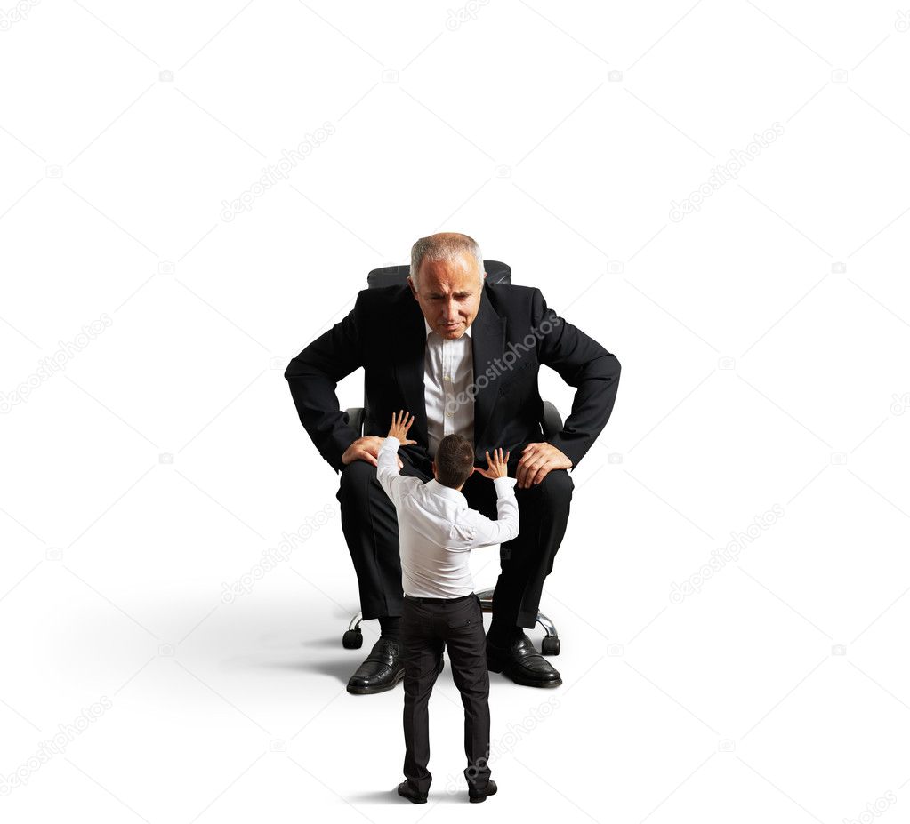 boss looking at small scared worker