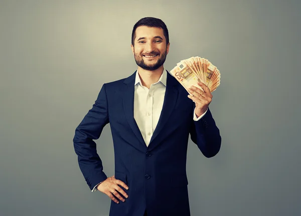 Hombre de negocios con éxito sosteniendo papel moneda — Foto de Stock