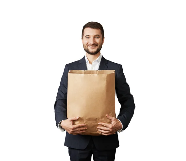 Homem segurando saco de papel e sorrindo — Fotografia de Stock