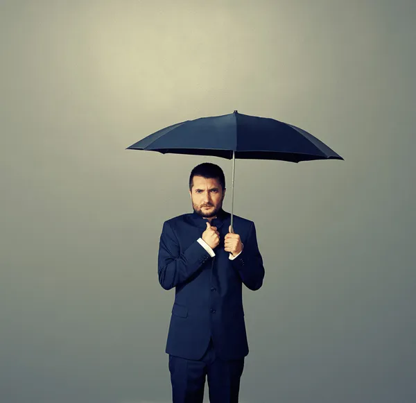 Man under black umbrella over dark — Stock Photo, Image