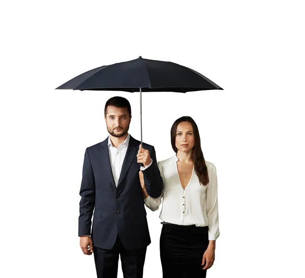 Serious couple under umbrella — Stock Photo, Image