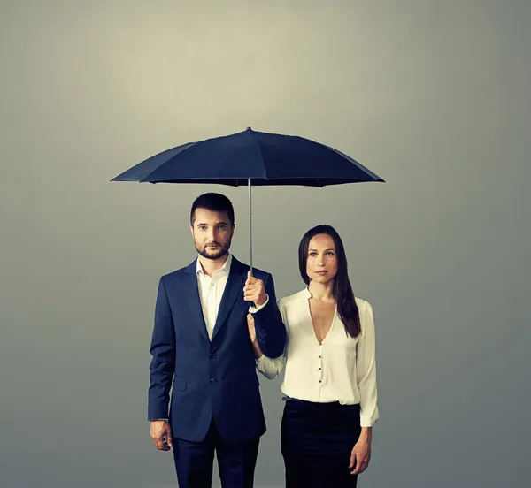 Couple under umbrella over dark — Stock Photo, Image