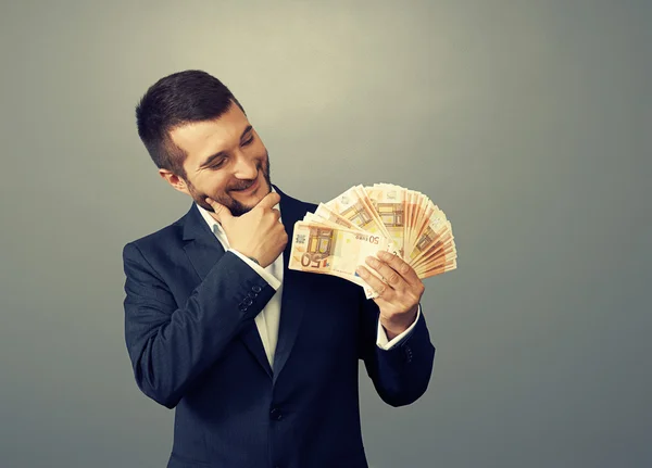 Man looking at money — Stock Photo, Image