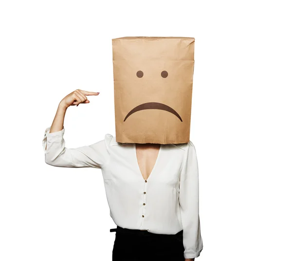 Depressed woman pointing at paper bag — Stock Photo, Image