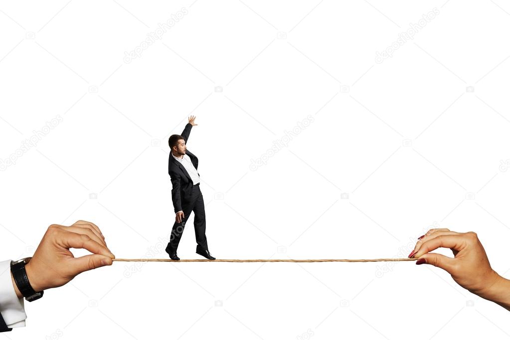 scared businessman balancing on the rope
