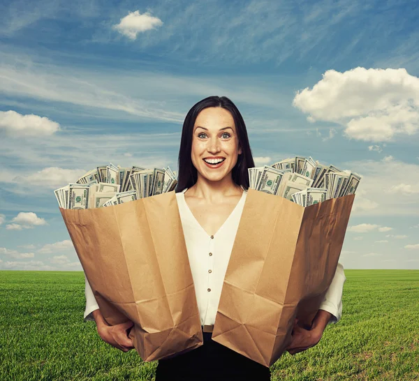 Excited young woman holding bag — Stock Photo, Image