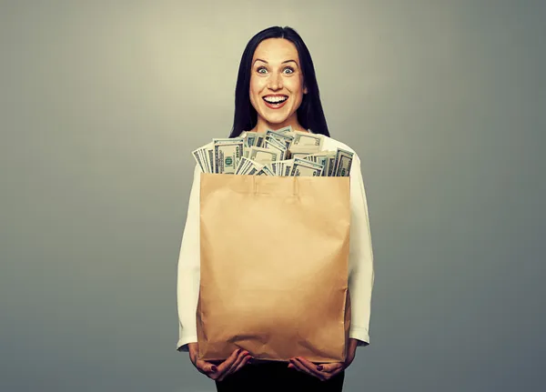 Excited young woman with money — Stock Photo, Image