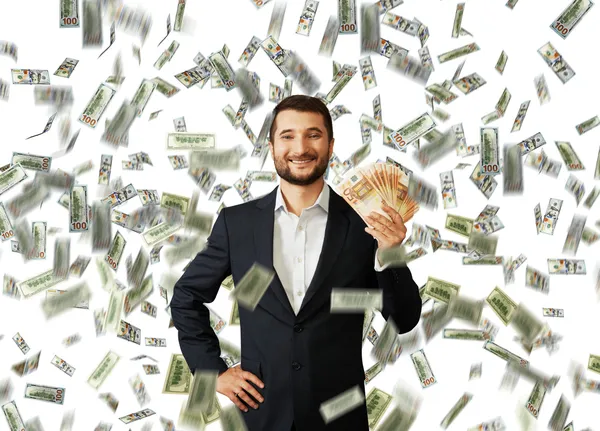 Uomo con euro in piedi sotto la pioggia di denaro — Foto Stock