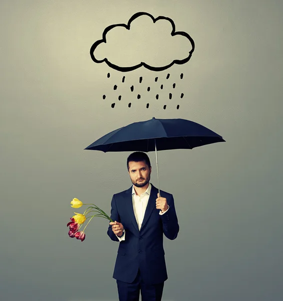 Sad young man with black umbrella — Stock Photo, Image