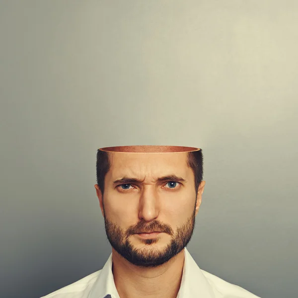 Serious young man with open head — Stock Photo, Image