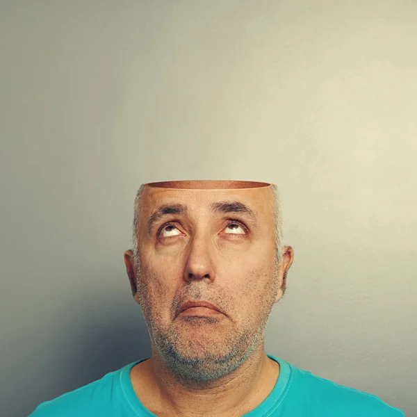 Senior man looking up at open head — Stock Photo, Image