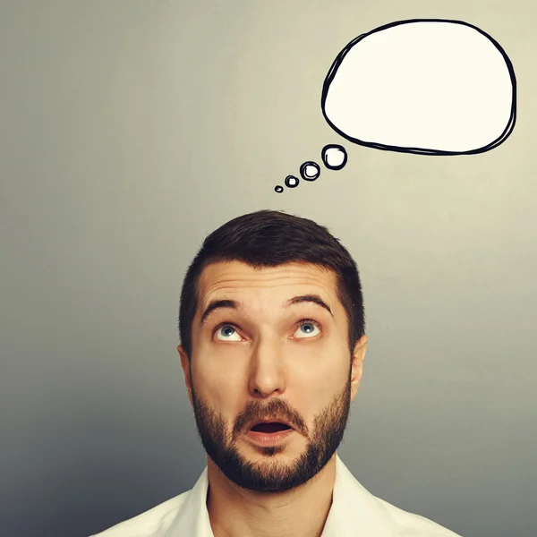 Amazed young man with speech bubble — Stock Photo, Image