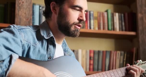 Homem cantando música e tocando guitarra em casa — Vídeo de Stock