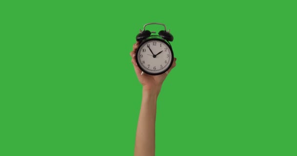 Hand of woman showing time on alarm clock — Stock Video