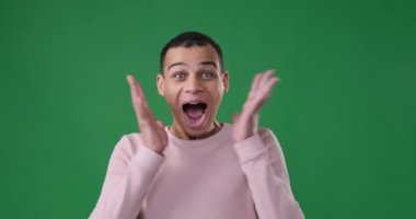 Sürpriz adam yeşil arka planda çığlık atıyor.