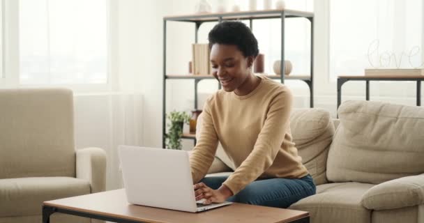 Mulher excitada usando laptop e celebrando o sucesso segurando um pacote de dólares em dinheiro — Vídeo de Stock