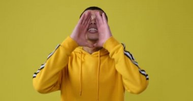 Elleri ağızında bağıran bir adam.