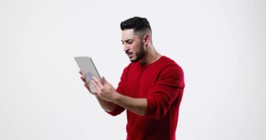 Unhappy man using digital tablet