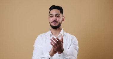 Young businessman applauding and smiling