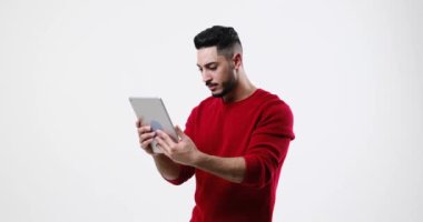 Amazed young man using digital tablet