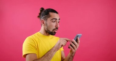 Happy man messaging using mobile phone