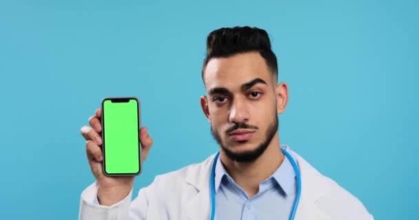 Serious doctor showing mobile phone — Stockvideo
