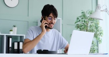 Businessman talking on mobile phone while working at office